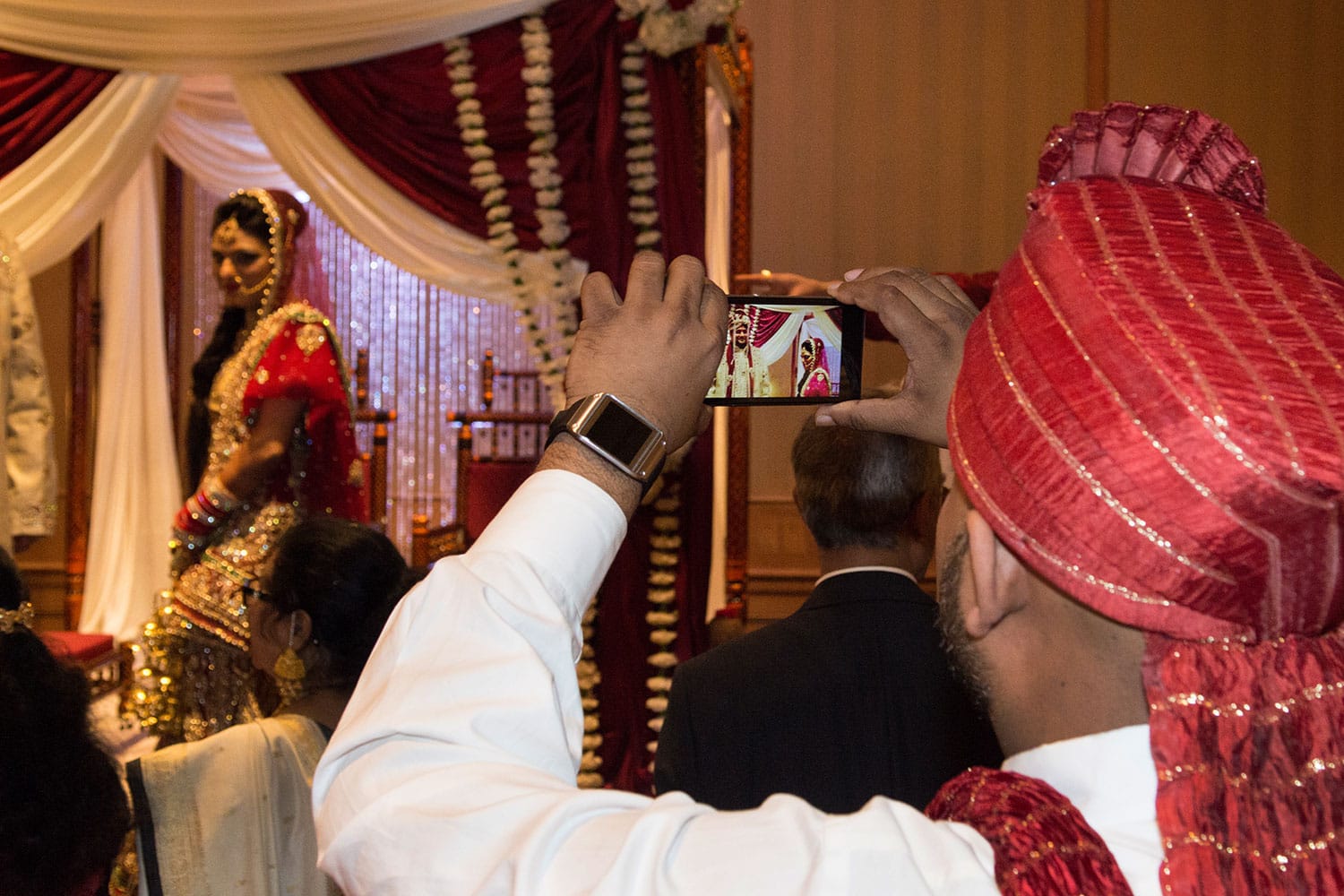 Guest using an iPhone to take pictures during a wedding