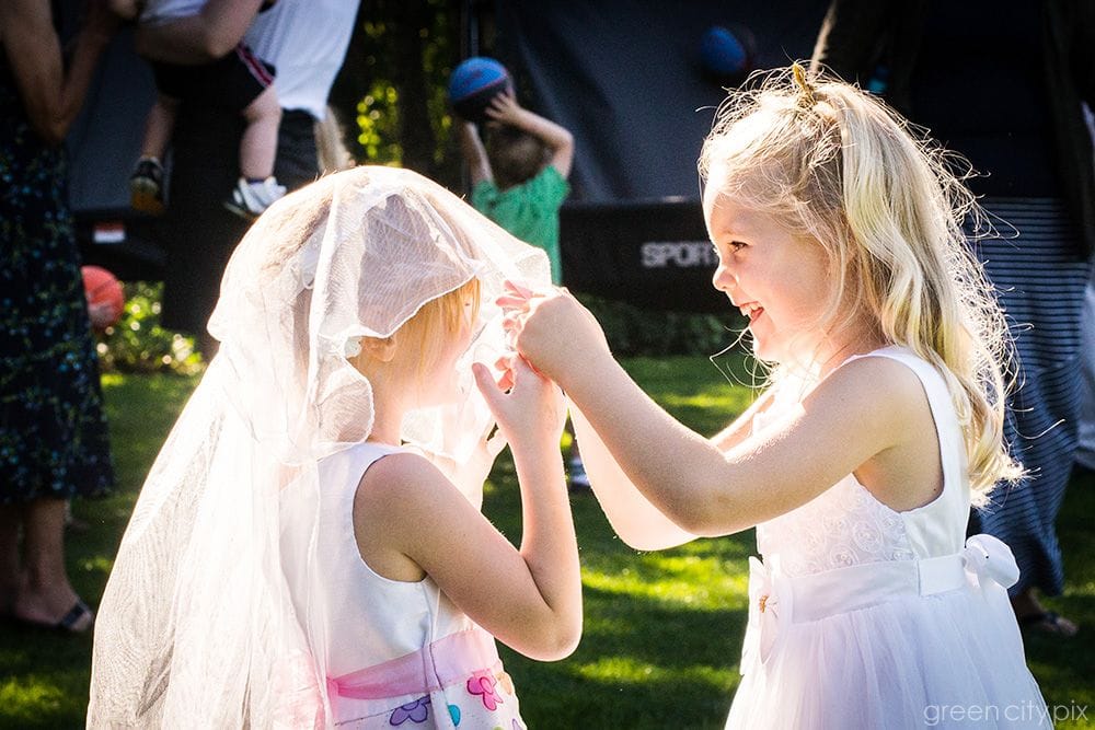 girls playing with wedding veil