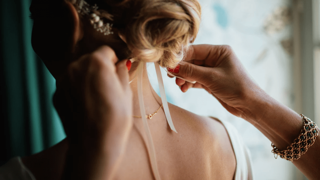 Mother of the bride adjusting bride's headband - Wedding dress details on Wedding photography checklist